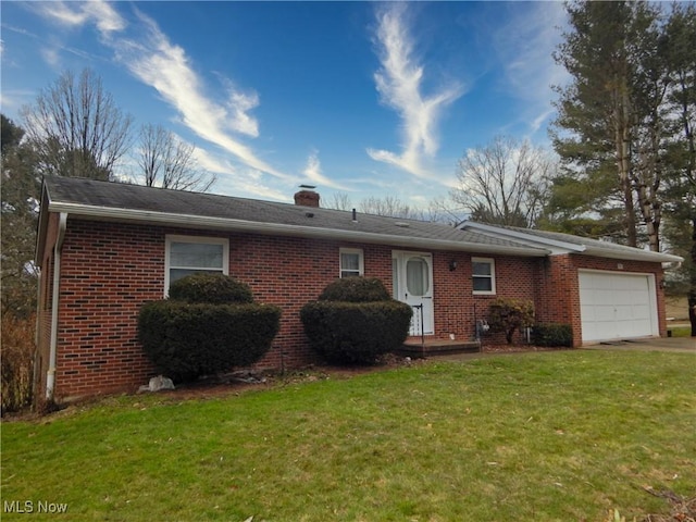 single story home featuring a garage, a chimney, a front lawn, and brick siding