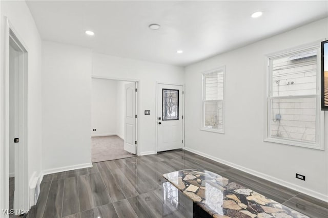 foyer with baseboards, dark wood-style floors, and recessed lighting