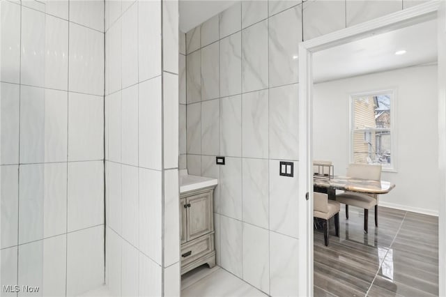 bathroom featuring tile walls and vanity