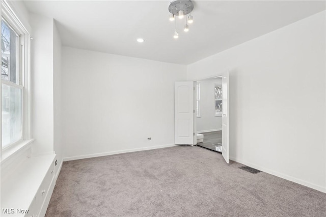 unfurnished bedroom with recessed lighting, visible vents, baseboards, and light colored carpet