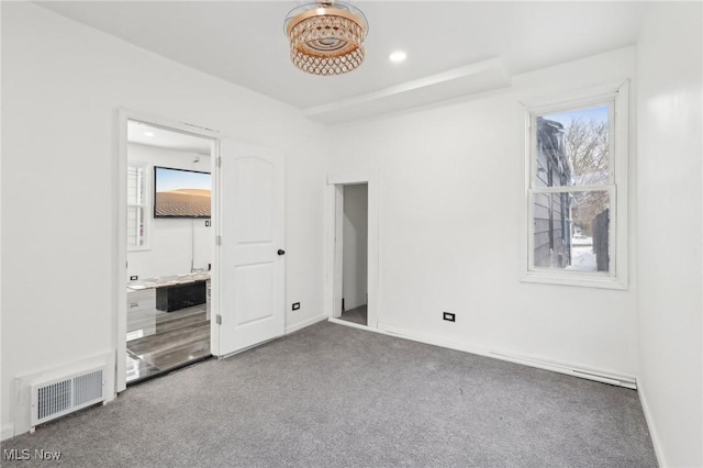 unfurnished bedroom with carpet, visible vents, baseboards, and multiple windows