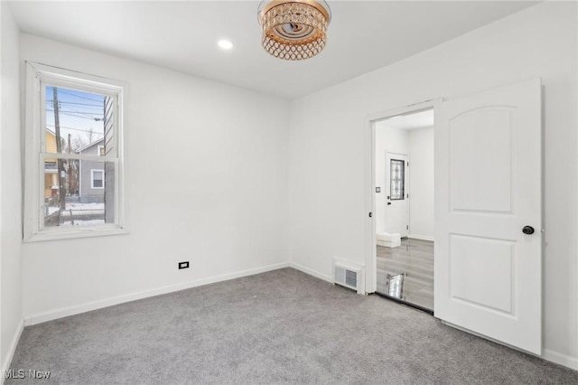 unfurnished room with baseboards, recessed lighting, visible vents, and light colored carpet