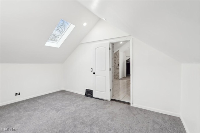 bonus room with vaulted ceiling with skylight, baseboards, and carpet flooring