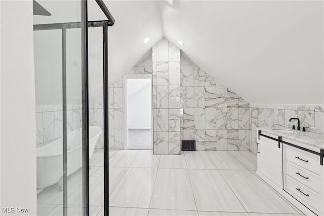 full bath with lofted ceiling, visible vents, tile walls, and vanity