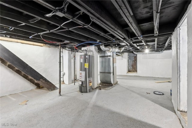 unfinished basement featuring gas water heater and heating unit