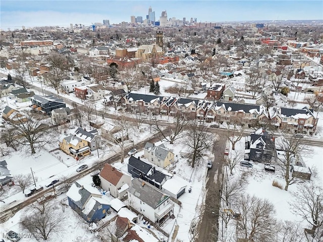 snowy aerial view with a city view