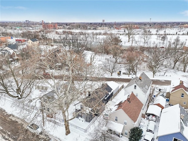 snowy aerial view featuring a residential view