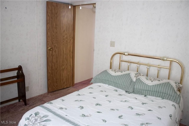 bedroom featuring carpet and wallpapered walls