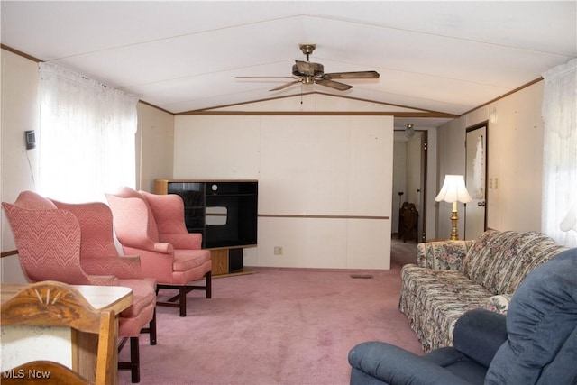 living room with lofted ceiling, ornamental molding, light carpet, and a ceiling fan