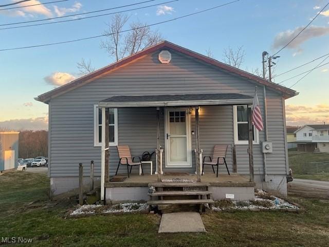 bungalow-style house featuring crawl space, a porch, and a front yard