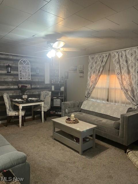 living room featuring carpet floors and a ceiling fan