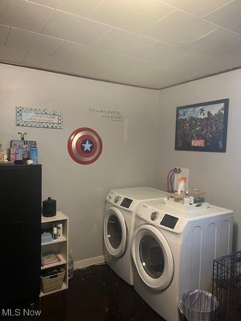 laundry room featuring laundry area, washer and clothes dryer, and baseboards