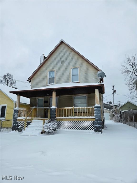 view of front facade with a porch and fence