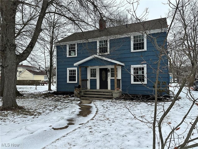 colonial-style house with a chimney