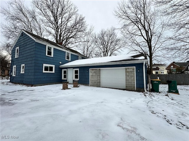 view of front of house with an attached garage and fence