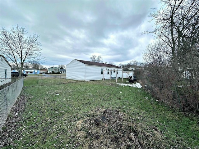 view of yard featuring fence and a residential view