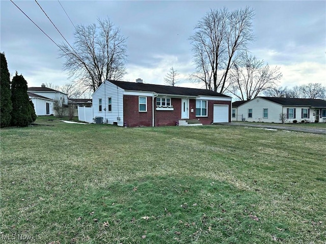 ranch-style home with a garage, central air condition unit, a front yard, and brick siding