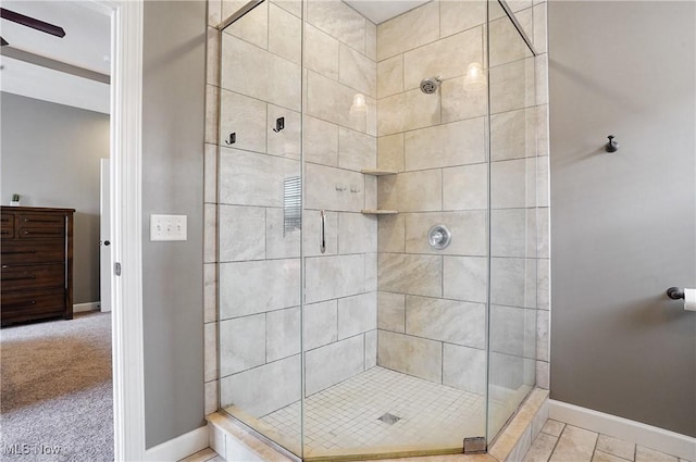 bathroom featuring a stall shower and baseboards