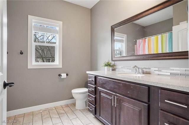 full bathroom with toilet, visible vents, vanity, baseboards, and tile patterned floors