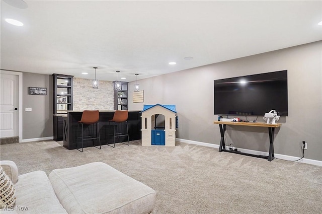 living area featuring baseboards, light colored carpet, and a dry bar