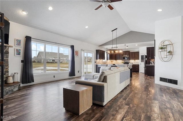 living area with dark wood-style floors, recessed lighting, visible vents, baseboards, and ceiling fan with notable chandelier