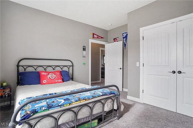 bedroom with carpet floors, a closet, and baseboards