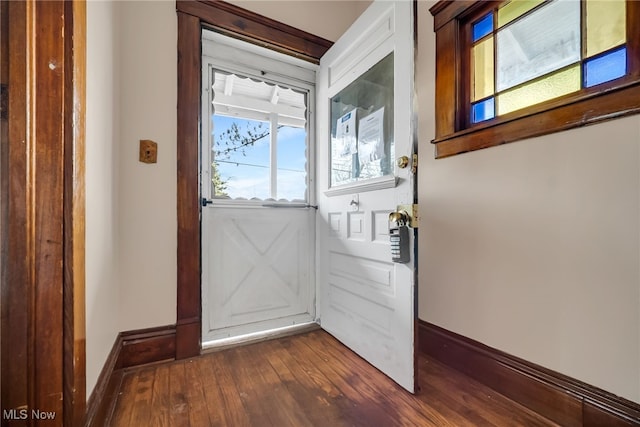 entryway featuring dark wood-type flooring and baseboards