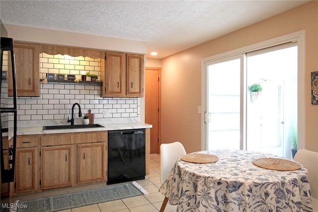 kitchen featuring a sink, light countertops, backsplash, dishwasher, and brown cabinetry