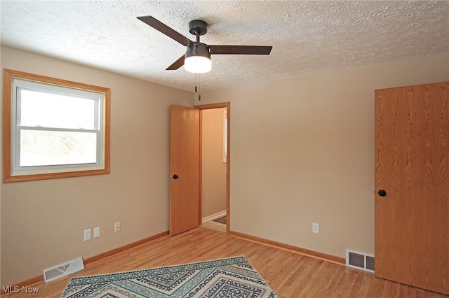 unfurnished bedroom featuring light wood-type flooring, visible vents, and baseboards