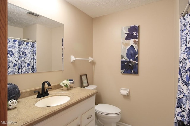 full bath featuring visible vents, a textured ceiling, toilet, and vanity