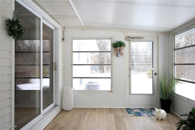 interior space with vaulted ceiling, plenty of natural light, and light wood-style flooring