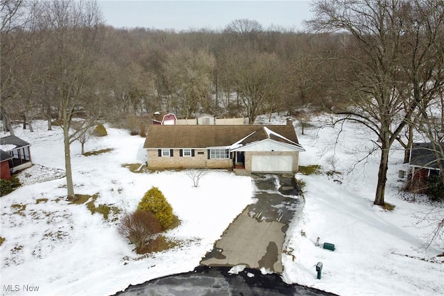 snowy aerial view with a view of trees