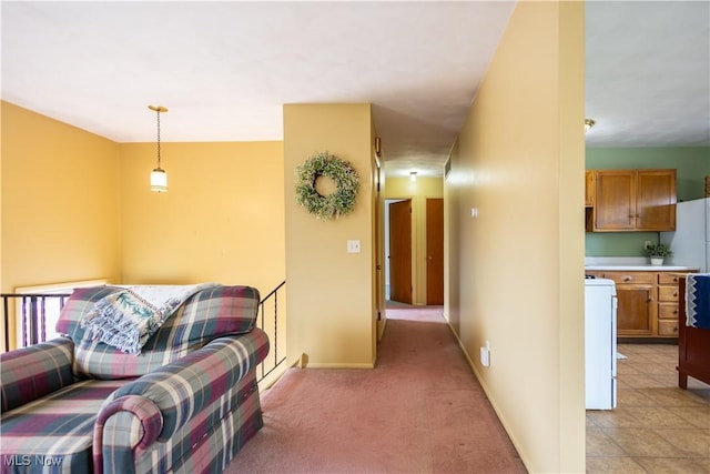 corridor featuring light carpet and baseboards