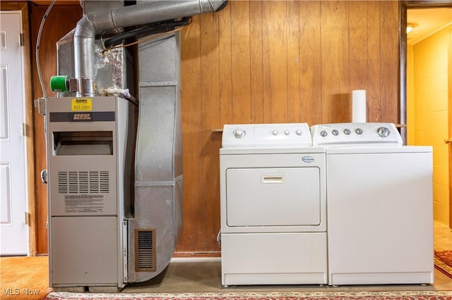 clothes washing area with laundry area, washing machine and clothes dryer, and heating unit