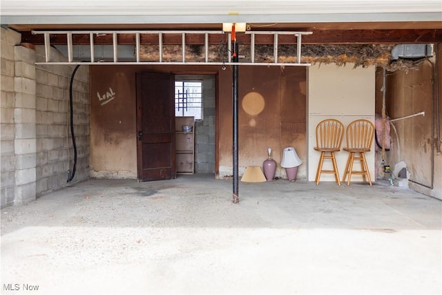 garage with concrete block wall