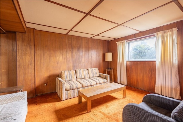 living room featuring light carpet and wood walls