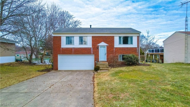 bi-level home with a garage, a front yard, concrete driveway, and brick siding