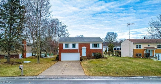 bi-level home with driveway, an attached garage, a front lawn, and brick siding