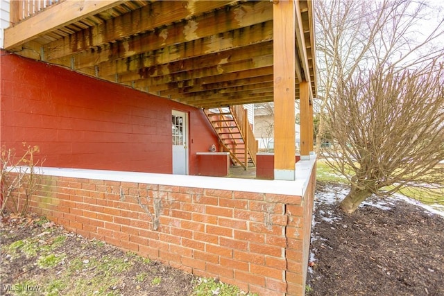 exterior space with brick siding and stairs