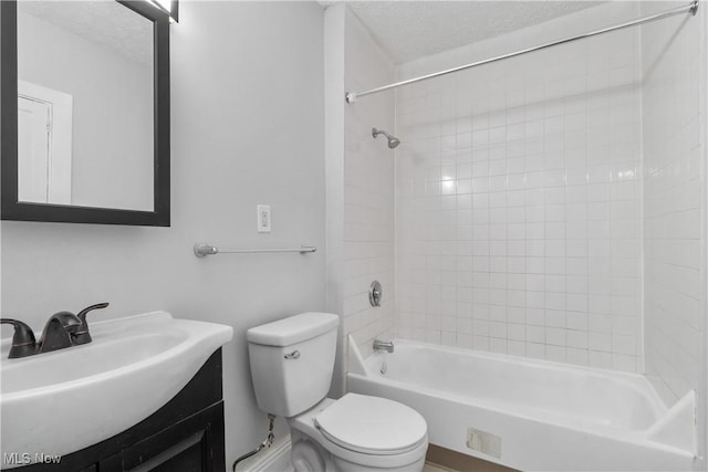 full bath with  shower combination, toilet, a textured ceiling, and vanity