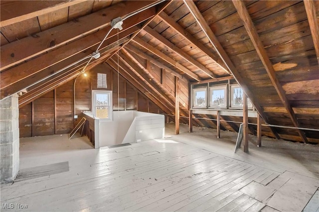 unfinished attic featuring an upstairs landing