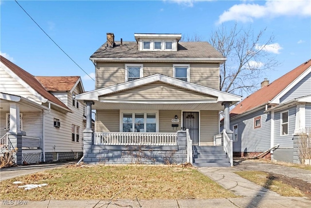 american foursquare style home with a porch