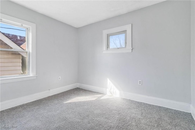 spare room with carpet flooring and baseboards