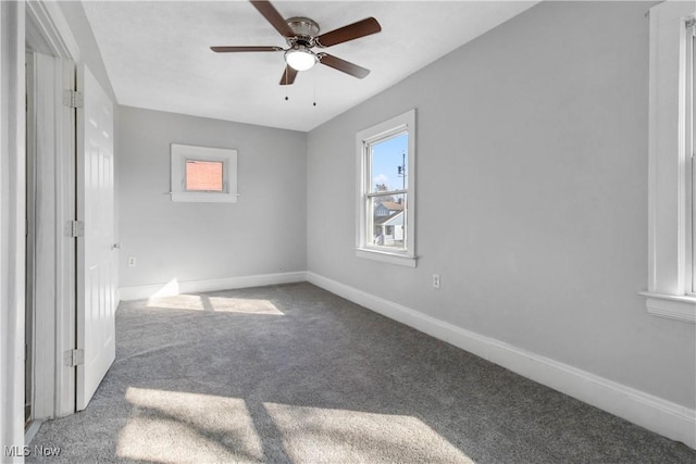 unfurnished bedroom featuring carpet, baseboards, and a ceiling fan