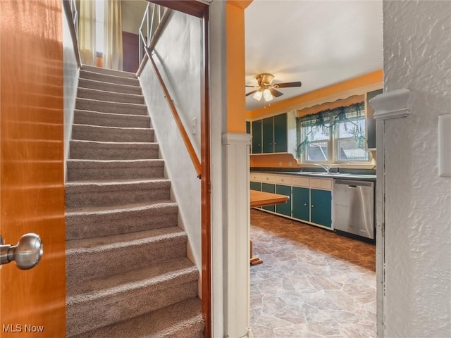 stairs with a ceiling fan and stone finish floor