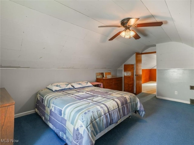 bedroom with lofted ceiling, visible vents, dark carpet, ceiling fan, and baseboards