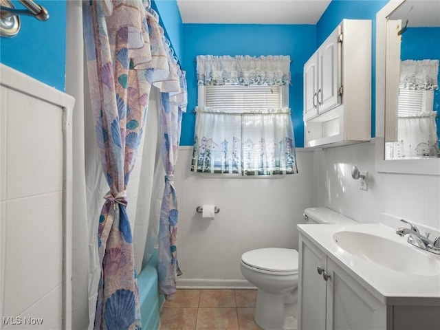 full bath featuring toilet, plenty of natural light, tile patterned flooring, and vanity