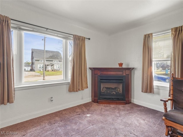 unfurnished room with carpet, a fireplace, baseboards, and a wealth of natural light