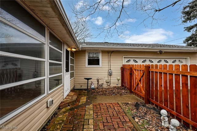 view of property exterior featuring a garage and fence