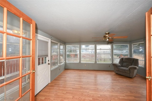 sunroom / solarium featuring ceiling fan